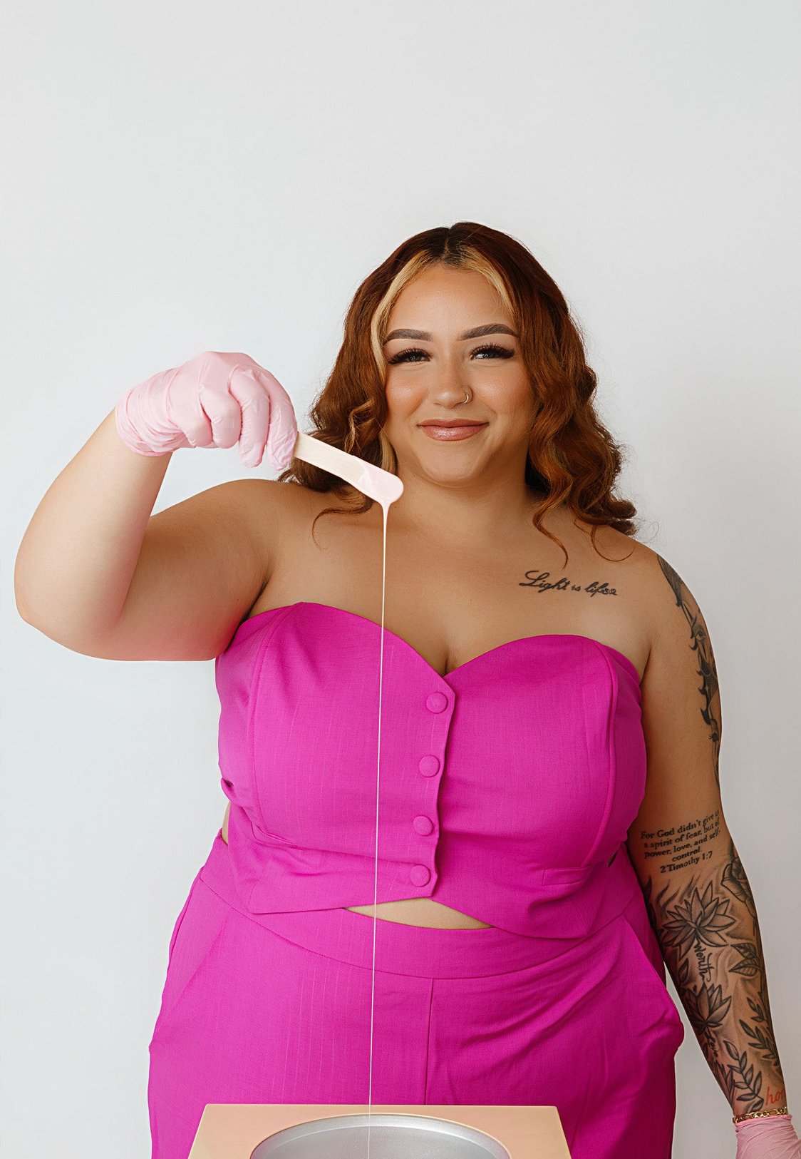 Gwen Johnson with a wax spatula and warmer at Geespot Aesthetics in Colorado Springs